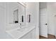 This bathroom features a modern vanity with a square mirror, quartz countertop, and sleek faucet at 5004 Lakemont Dr, Raleigh, NC 27609
