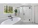 Bright bathroom featuring a soaking tub, black fixtures and a glass enclosed shower at 5004 Lakemont Dr, Raleigh, NC 27609