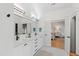 Bright bathroom featuring double sinks and a doorway view into a bright bedroom at 5004 Lakemont Dr, Raleigh, NC 27609