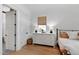 Comfortable bedroom features a large dresser, and multiple windows with woven shades at 5004 Lakemont Dr, Raleigh, NC 27609