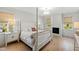 Bright bedroom features a four-poster bed, fireplace, wood floors and bright, natural light at 5004 Lakemont Dr, Raleigh, NC 27609
