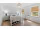 This airy bedroom boasts stylish light fixture, wooden floors, and natural light from the window at 5004 Lakemont Dr, Raleigh, NC 27609