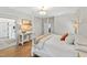 This bedroom showcases a comfortable bed, stylish furniture, and wood floors creating a relaxing space at 5004 Lakemont Dr, Raleigh, NC 27609