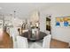 This open-concept dining area boasts a round table, white seating, and stylish light fixtures at 5004 Lakemont Dr, Raleigh, NC 27609