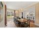 Elegant dining room with grasscloth walls, wooden table, and chandelier lighting with natural light at 5004 Lakemont Dr, Raleigh, NC 27609