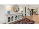 Beautiful foyer featuring a stylish sideboard, lamps, rug and a staircase at 5004 Lakemont Dr, Raleigh, NC 27609