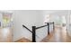 Second floor hallway showcasing wood floors, white walls, and three doorways at 5004 Lakemont Dr, Raleigh, NC 27609