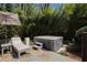 Relaxing backyard oasis with a hot tub, lounge chair, and tranquil landscaping for ultimate relaxation at 5004 Lakemont Dr, Raleigh, NC 27609