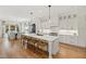 Modern white kitchen featuring a large island, sleek countertops, and pendant lighting at 5004 Lakemont Dr, Raleigh, NC 27609
