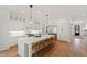 Beautiful white kitchen with a spacious island, modern appliances, and hardwood floors at 5004 Lakemont Dr, Raleigh, NC 27609
