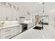 Bright kitchen featuring white cabinetry, an island with seating, and stainless steel appliances at 5004 Lakemont Dr, Raleigh, NC 27609