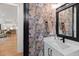 Charming powder room features patterned wallpaper, modern fixtures, and a marble vanity at 5004 Lakemont Dr, Raleigh, NC 27609