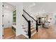 Staircase next to mud room leading into living room with hardwood flooring and a view of Gathering room at 5004 Lakemont Dr, Raleigh, NC 27609