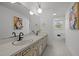 Spacious bathroom with double vanity, geometric tiled floors, and ample lighting at 5130 Guess Rd, Durham, NC 27712