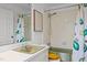 Bathroom featuring tiled shower with avocado-themed shower curtain, and olive drab fixtures at 5130 Guess Rd, Durham, NC 27712