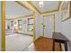 Welcoming entryway with hardwood floors, white walls with gold trim, and a view into the living room at 5130 Guess Rd, Durham, NC 27712