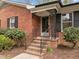 Close-up of the front entrance showcasing brick steps and decorative iron railings at 5130 Guess Rd, Durham, NC 27712