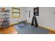 Home gym area with wood floors, neutral walls, weight training equipment and space for exercise at 5130 Guess Rd, Durham, NC 27712