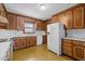 Traditional kitchen featuring wood cabinets, white countertops, and a white refrigerator at 5130 Guess Rd, Durham, NC 27712