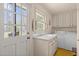 Functional laundry room with sink, white cabinets, and included washer and dryer at 5130 Guess Rd, Durham, NC 27712