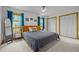 Bright main bedroom featuring large windows, ceiling fan, and double closets at 5130 Guess Rd, Durham, NC 27712