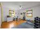 Bright home office/flex space with wood floors, white walls, and large windows offering natural light at 5130 Guess Rd, Durham, NC 27712