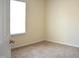 Cozy bedroom with neutral carpet, a window providing natural light, and a doorway at 536 Dearing Dr, Haw River, NC 27258