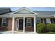 Charming brick home with a covered front entrance, white columns, and black shutters, creating a welcoming curb appeal at 536 Dearing Dr, Haw River, NC 27258
