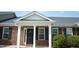 Charming brick home showcasing a covered front porch with classic black shutters and manicured landscaping at 536 Dearing Dr, Haw River, NC 27258