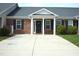 Inviting brick home with a covered front porch, dark shutters, and a well-maintained driveway at 536 Dearing Dr, Haw River, NC 27258