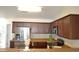 Kitchen with stainless steel appliances, wood cabinets, and view to hallway at 536 Dearing Dr, Haw River, NC 27258