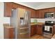 Kitchen with stainless steel refrigerator, dark cabinets and laminate countertops at 536 Dearing Dr, Haw River, NC 27258