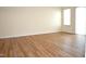 Spacious living room with new flooring and large windows, providing a bright and airy feel at 536 Dearing Dr, Haw River, NC 27258