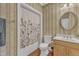 Cozy bathroom featuring a shower-tub combo, a single sink vanity, and charming wallpaper at 5521 Erinvale Ct, Holly Springs, NC 27540