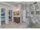 Bathroom featuring dual vanities, modern fixtures, and a glass enclosed shower at 5521 Erinvale Ct, Holly Springs, NC 27540