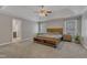 A primary bedroom with a natural wood bed set, ceiling fan, and lots of natural light at 5521 Erinvale Ct, Holly Springs, NC 27540