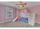 Bedroom featuring a bunk bed with slide and a ceiling fan at 5521 Erinvale Ct, Holly Springs, NC 27540