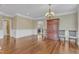 Dining room featuring hardwood floors, neutral decor, and a view of the adjacent living room at 5521 Erinvale Ct, Holly Springs, NC 27540