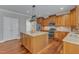 Gourmet kitchen featuring stainless steel appliances, granite countertops, and a central island at 5521 Erinvale Ct, Holly Springs, NC 27540