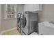 Well-lit laundry room features modern appliances and ample counter space at 5521 Erinvale Ct, Holly Springs, NC 27540