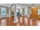 Bright living room showcasing hardwood floors, wainscoting, and classic architectural columns and trim at 5521 Erinvale Ct, Holly Springs, NC 27540