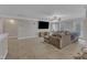 Comfortable living room with large sectional sofa, ceiling fan and neutral decor at 5521 Erinvale Ct, Holly Springs, NC 27540