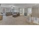 Cozy living room with a large sectional sofa and neutral colored carpeting at 5521 Erinvale Ct, Holly Springs, NC 27540