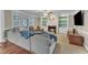 Cozy living room with fireplace, built-in shelving, and leather armchairs at 5521 Erinvale Ct, Holly Springs, NC 27540