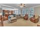 Comfortable living room with large windows and easy access to the kitchen at 5521 Erinvale Ct, Holly Springs, NC 27540