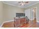 Spacious office features hardwood floors, three monitors, and a desk, perfect for a productive work environment at 5521 Erinvale Ct, Holly Springs, NC 27540