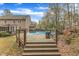 Backyard with pool and wooden deck, ideal for outdoor relaxation and entertaining at 5521 Erinvale Ct, Holly Springs, NC 27540