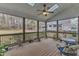 Cozy screened-in porch featuring a ceiling fan and an inviting outdoor sitting area at 5521 Erinvale Ct, Holly Springs, NC 27540