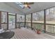Inviting screened porch with vaulted ceiling, fan, and tranquil views of the backyard and wooded area at 5521 Erinvale Ct, Holly Springs, NC 27540