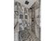 Walk-in shower featuring designer tile, a built-in bench and modern shower fixture at 5521 Erinvale Ct, Holly Springs, NC 27540